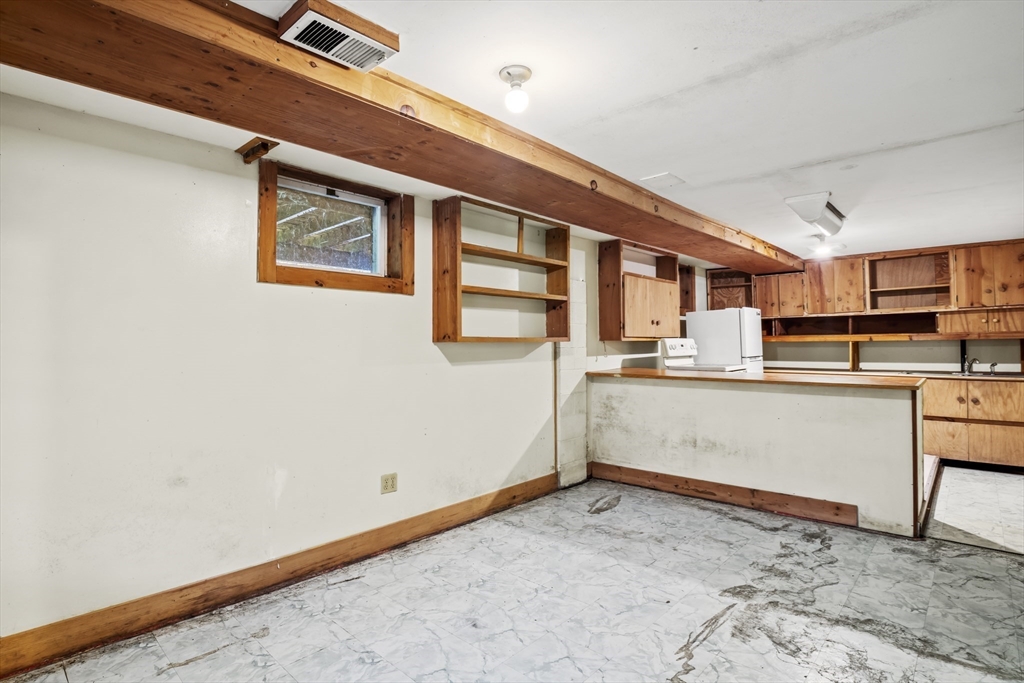 55 Putney Road Leverett, MA 01054 - Photo 28 of 40 a room with stainless steel appliances kitchen island granite countertop a refrigerator and a stove top oven