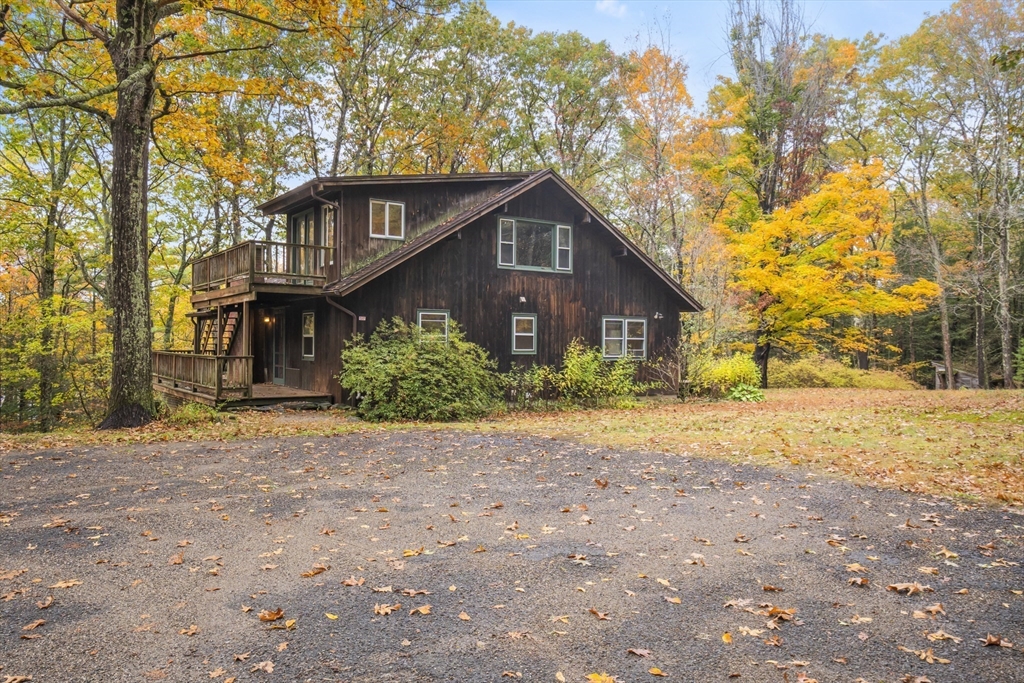 55 Putney Road Leverett, MA 01054 - Photo 36 of 40 a front view of a house with a yard and garage