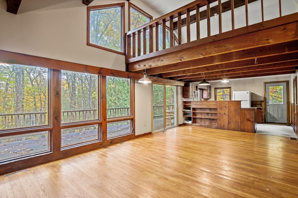 55 Putney Road Leverett, MA 01054 - Photo 5 of 40 a view of an empty room with wooden floor and windows