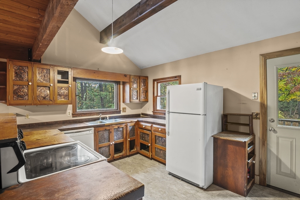 55 Putney Road Leverett, MA 01054 - Photo 9 of 40 a kitchen with a refrigerator and a sink