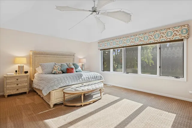 a bedroom with a large bed and a large window