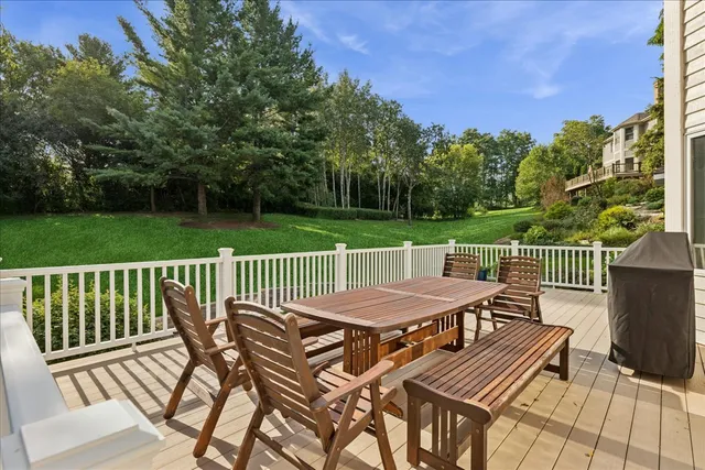 a view of a patio on wooden deck and a yard
