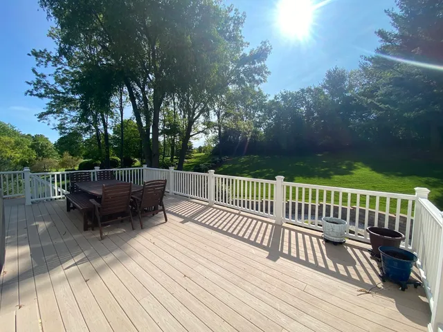 a view of a deck with wooden floor and outdoor seating