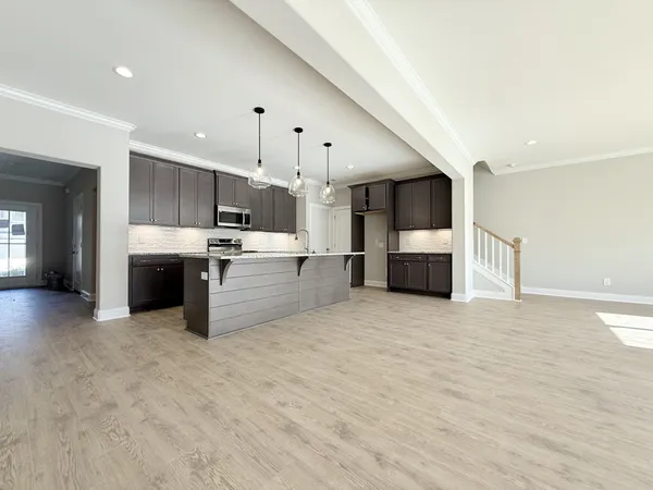a large kitchen with a stove a refrigerator and a sink