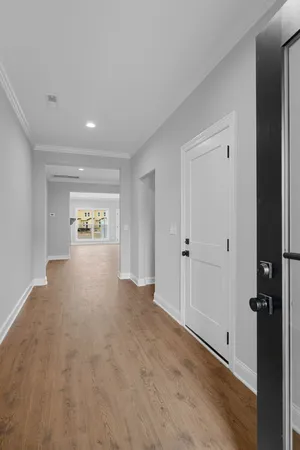 a view of a hallway with wooden floor
