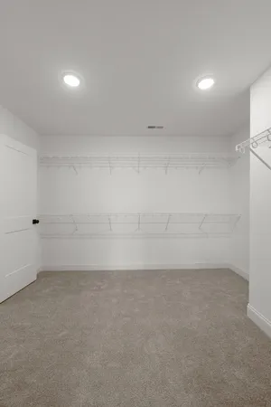 an empty room with wooden floor & windows