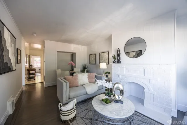 a living room with furniture a mirror and a fireplace