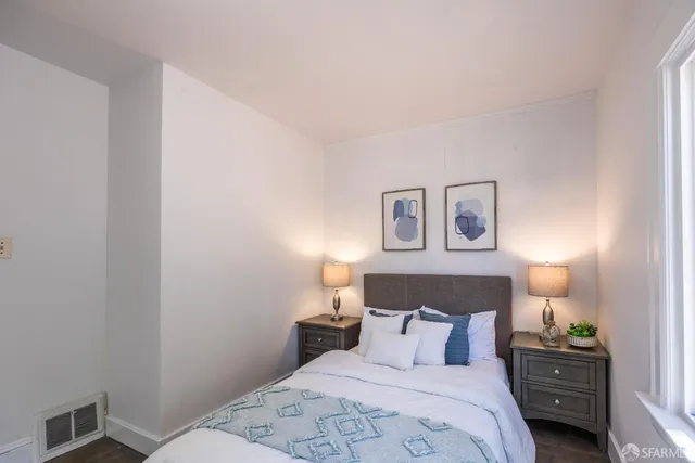 a bedroom with a bed and a lamp