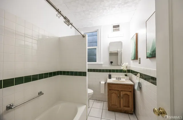 a bathroom with a bathtub sink and mirror