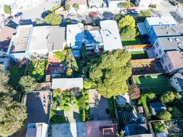 an aerial view of a houses and yard