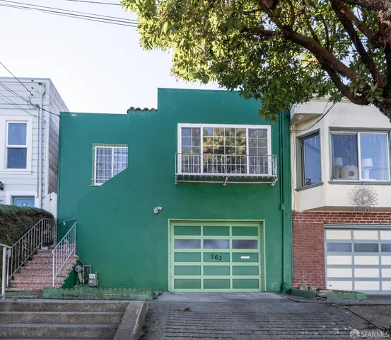 a front view of a house with a garden