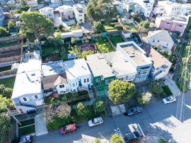 an aerial view of a house with a yard and outdoor seating