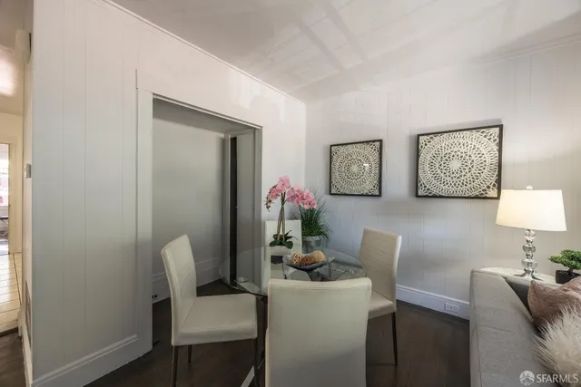 a dining room with furniture and wooden floor