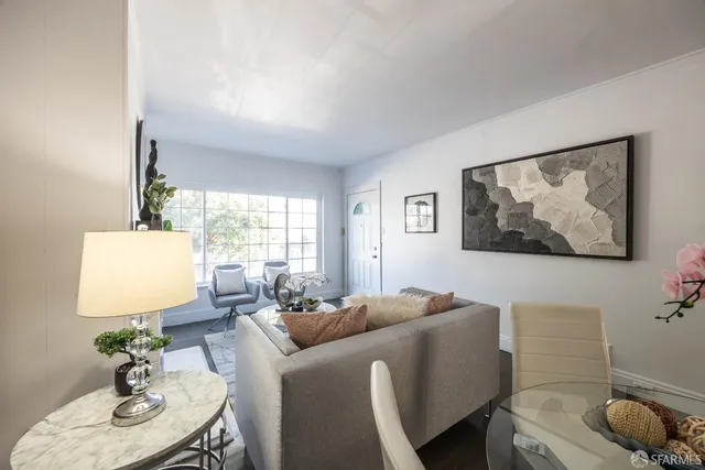 a living room with furniture flowerpot and window