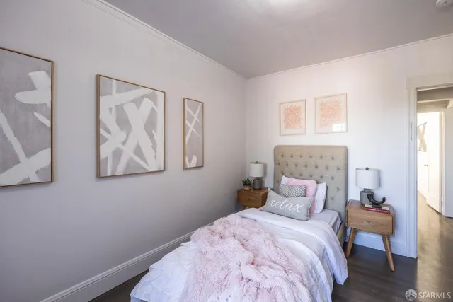 a bedroom with a bed and a wall painting