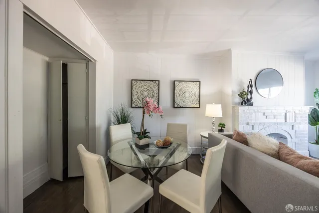 a dining room with furniture and a mirror