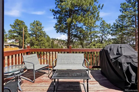 a view of a chairs and table on the balcony