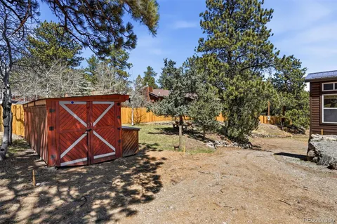 a view of a wooden house with a yard