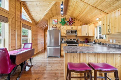 a kitchen with stainless steel appliances granite countertop a refrigerator and a sink