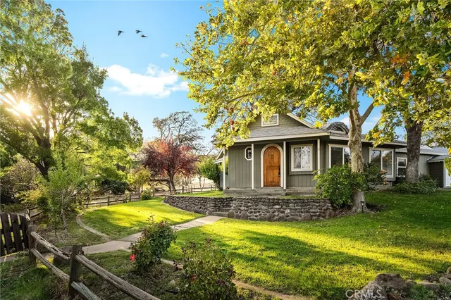 a front view of house with yard and swimming pool