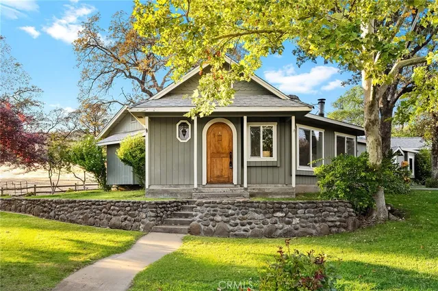 a front view of house with yard and swimming pool