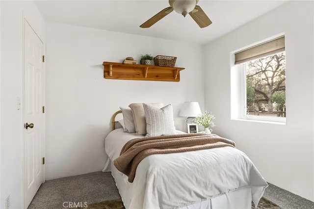a bathroom with a granite countertop sink a toilet and a mirror