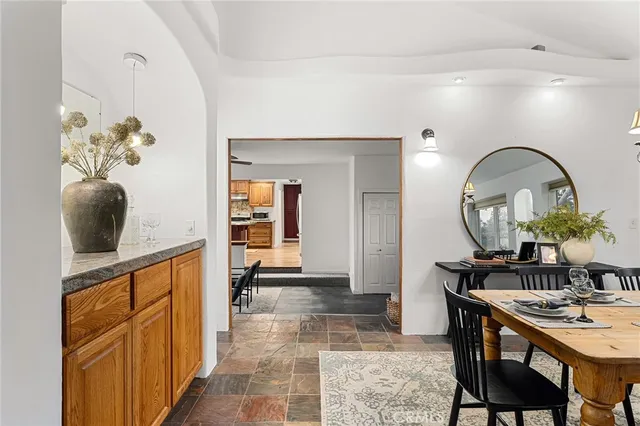 a dining room with wooden floor and a rug