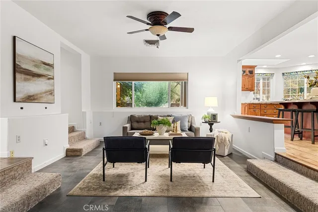a living room with fireplace furniture and a window