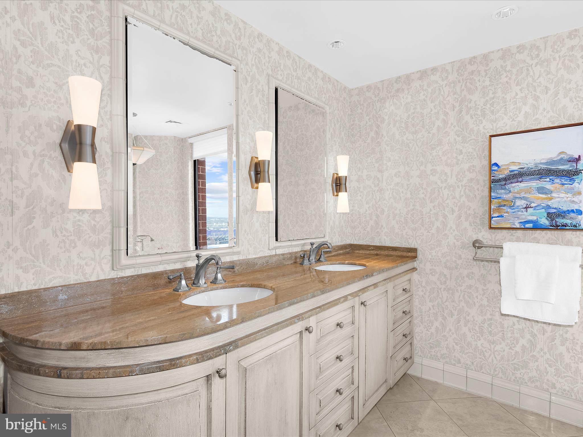 10 East Lee Street, Unit 2405 Baltimore, MD 21202 - Photo 11 of 50 a bathroom with double sink and a mirror