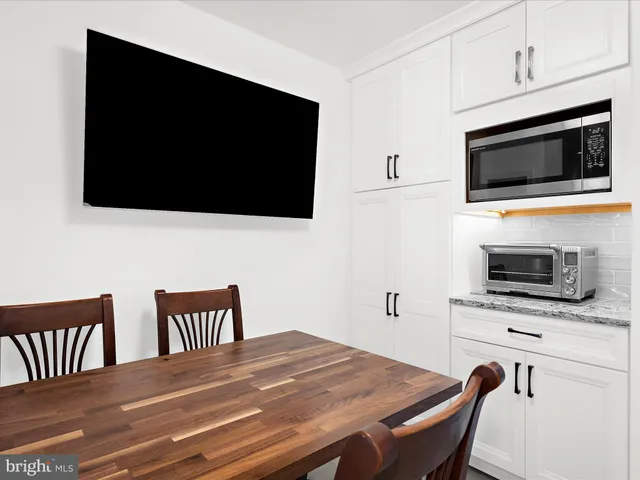 a kitchen with stainless steel appliances a stove microwave and cabinets