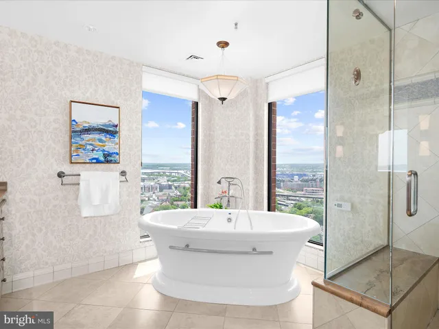 a view of a bathroom with a tub shower and mirror