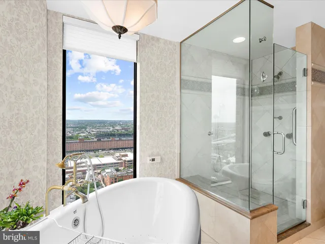 a bathroom with a tub shower and sink