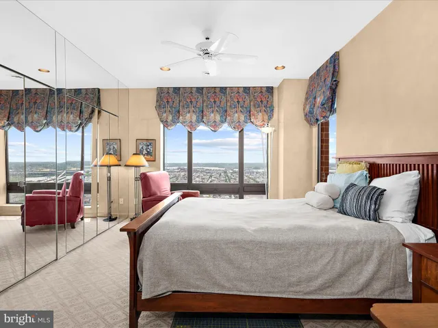 a bedroom with a large bed and a large window