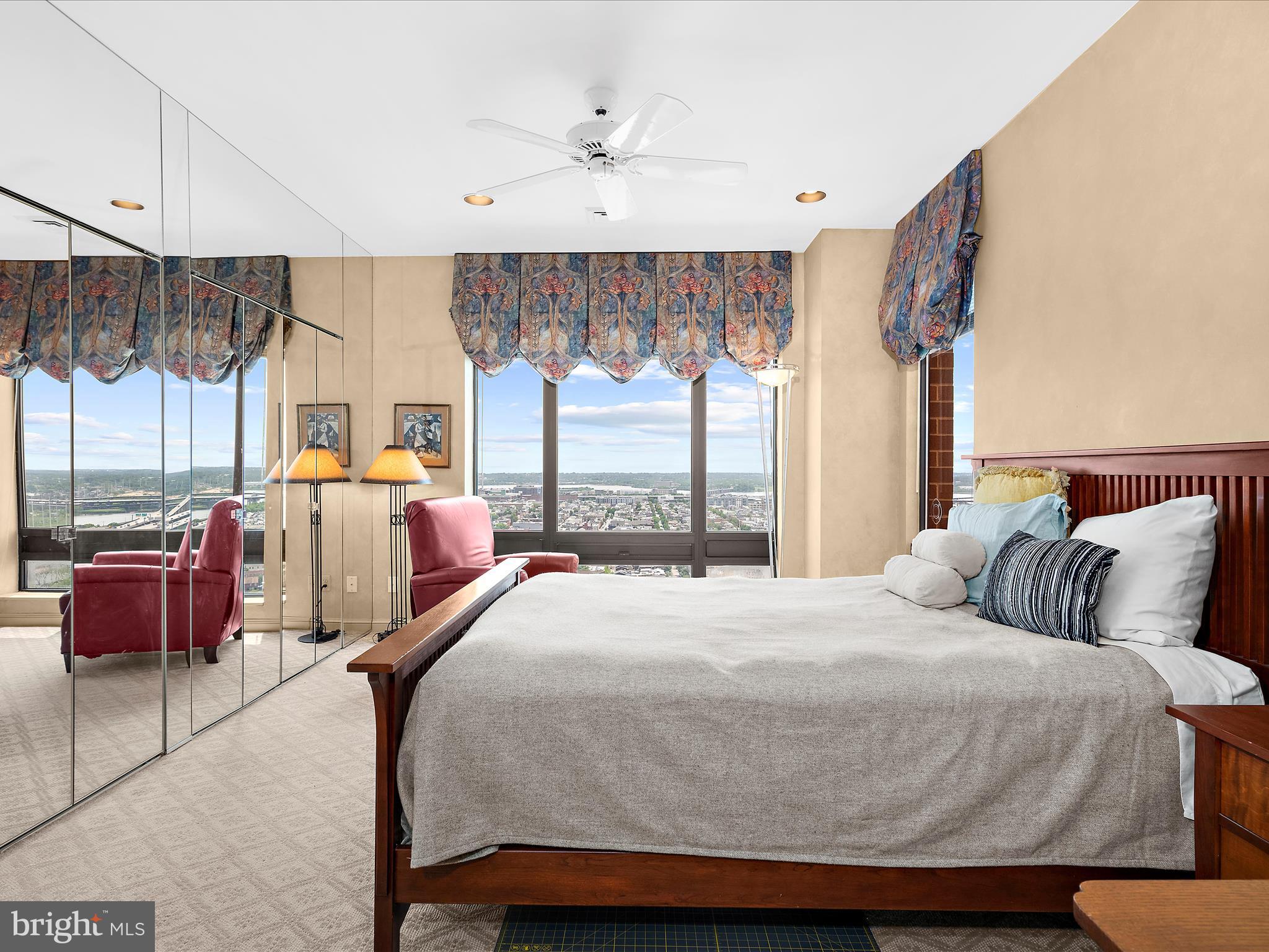 10 East Lee Street, Unit 2405 Baltimore, MD 21202 - Photo 18 of 50 a bedroom with a large bed and a large window