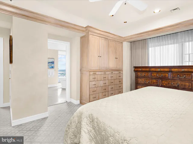 a spacious bedroom with a large bed and a dresser