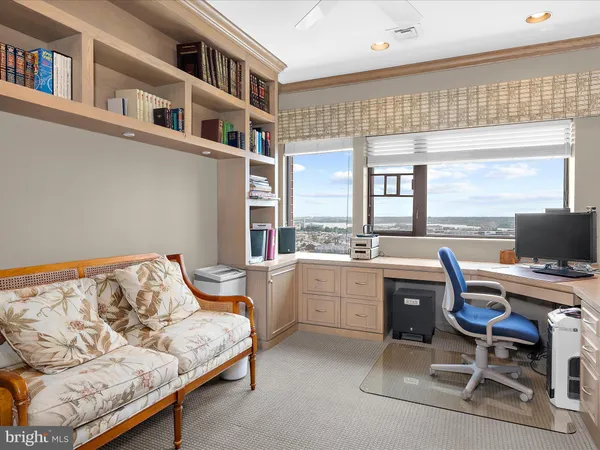 a bedroom with furniture and a large window