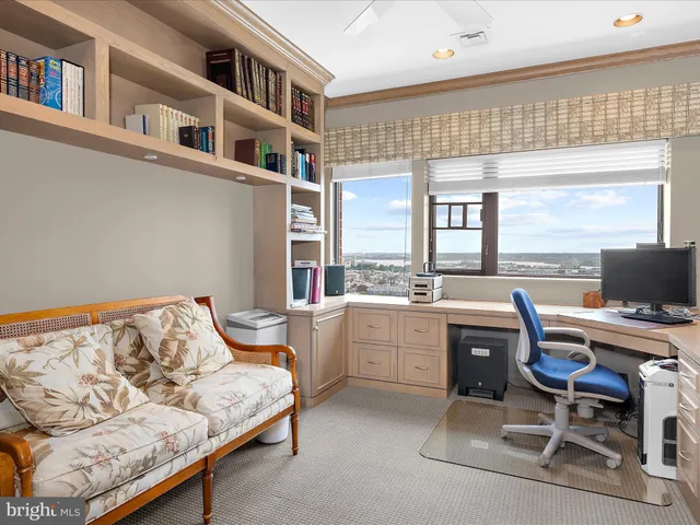 a bedroom with furniture and a large window
