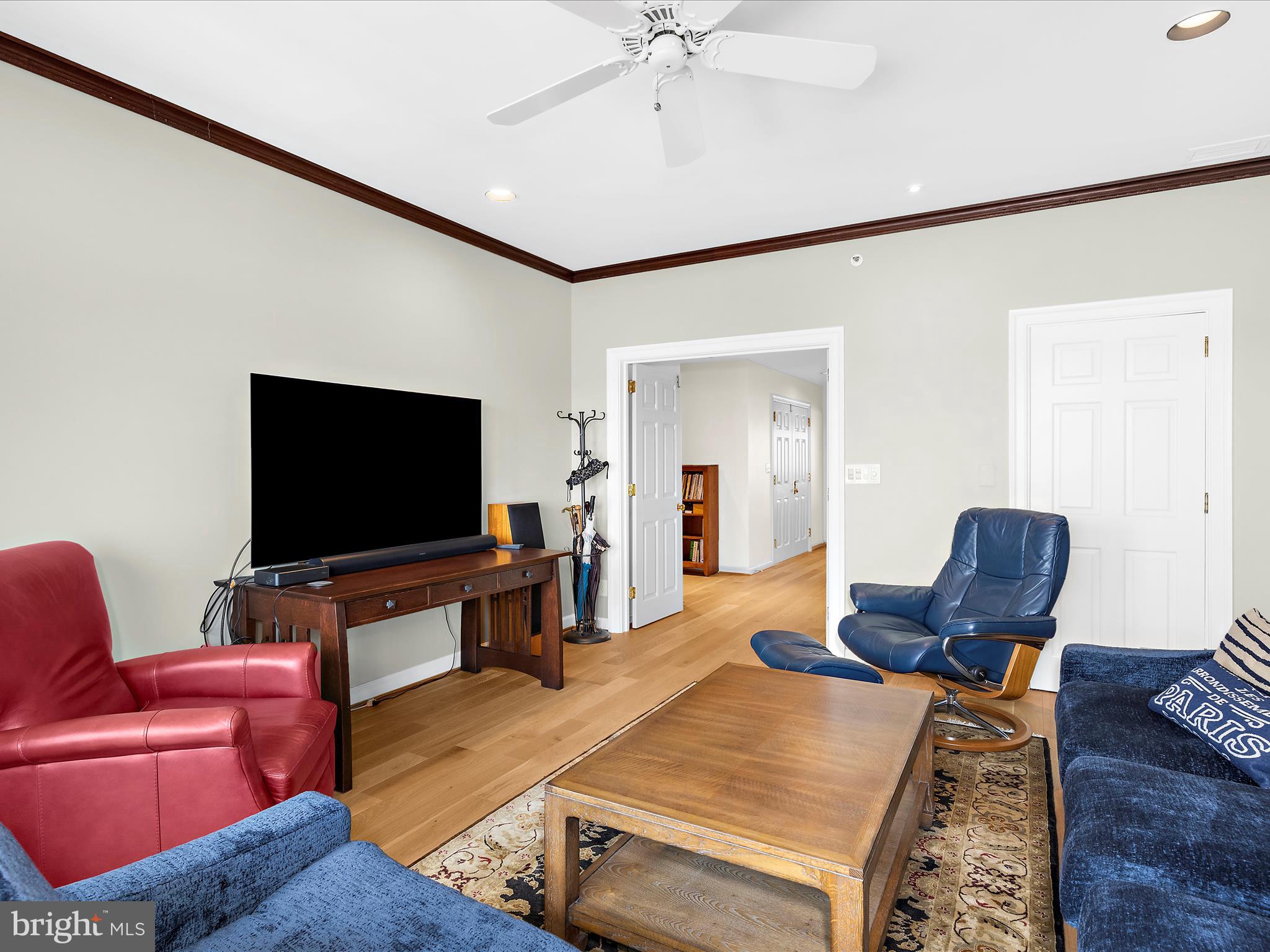 10 East Lee Street, Unit 2405 Baltimore, MD 21202 - Photo 25 of 50 a living room with furniture and a flat screen tv
