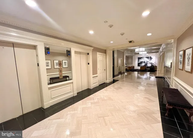a room with lots of wooden furniture and windows