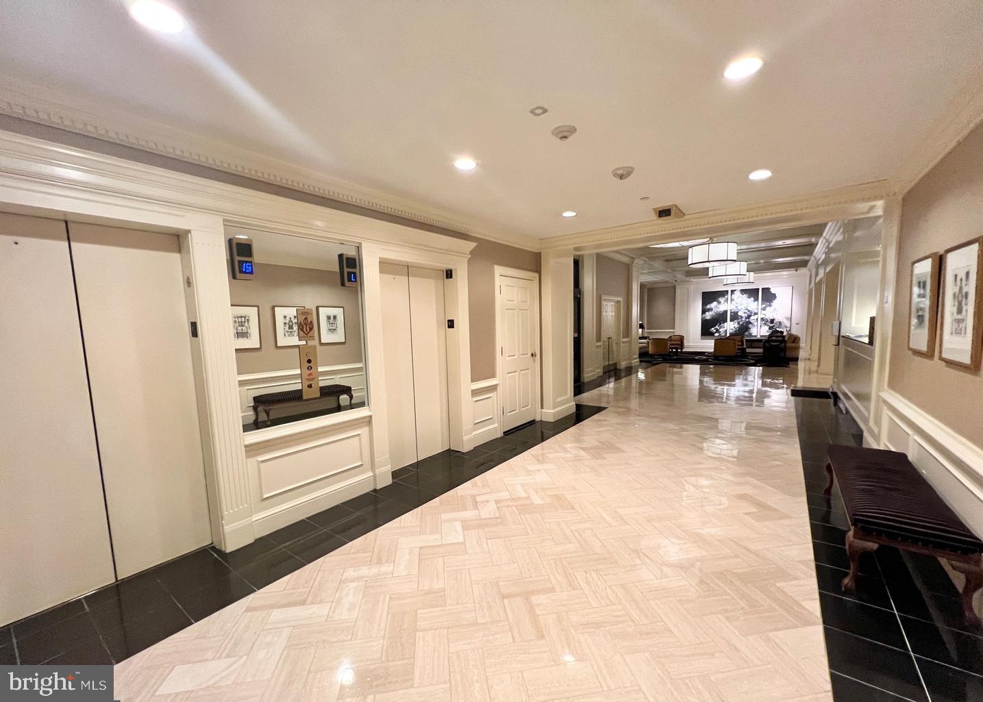 10 East Lee Street, Unit 2405 Baltimore, MD 21202 - Photo 36 of 50 a view of a hallway with furniture and a kitchen