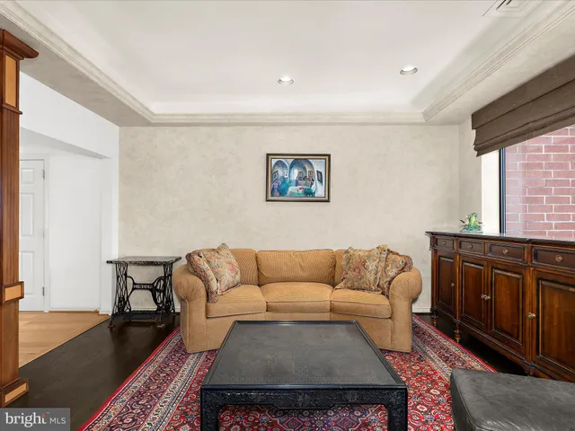 a living room with furniture a rug and a window