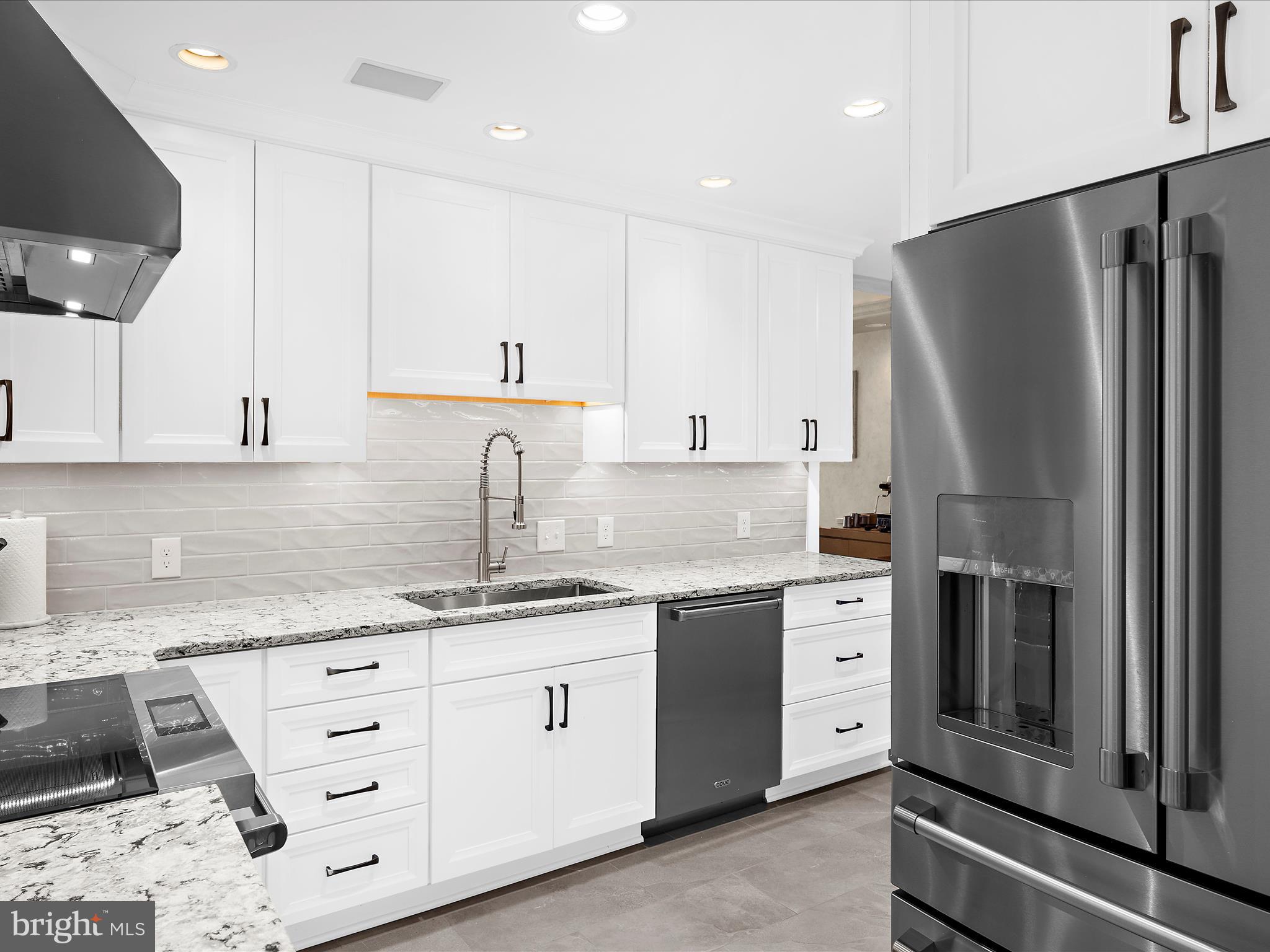 10 East Lee Street, Unit 2405 Baltimore, MD 21202 - Photo 9 of 50 a kitchen with a sink stainless steel appliances and cabinets
