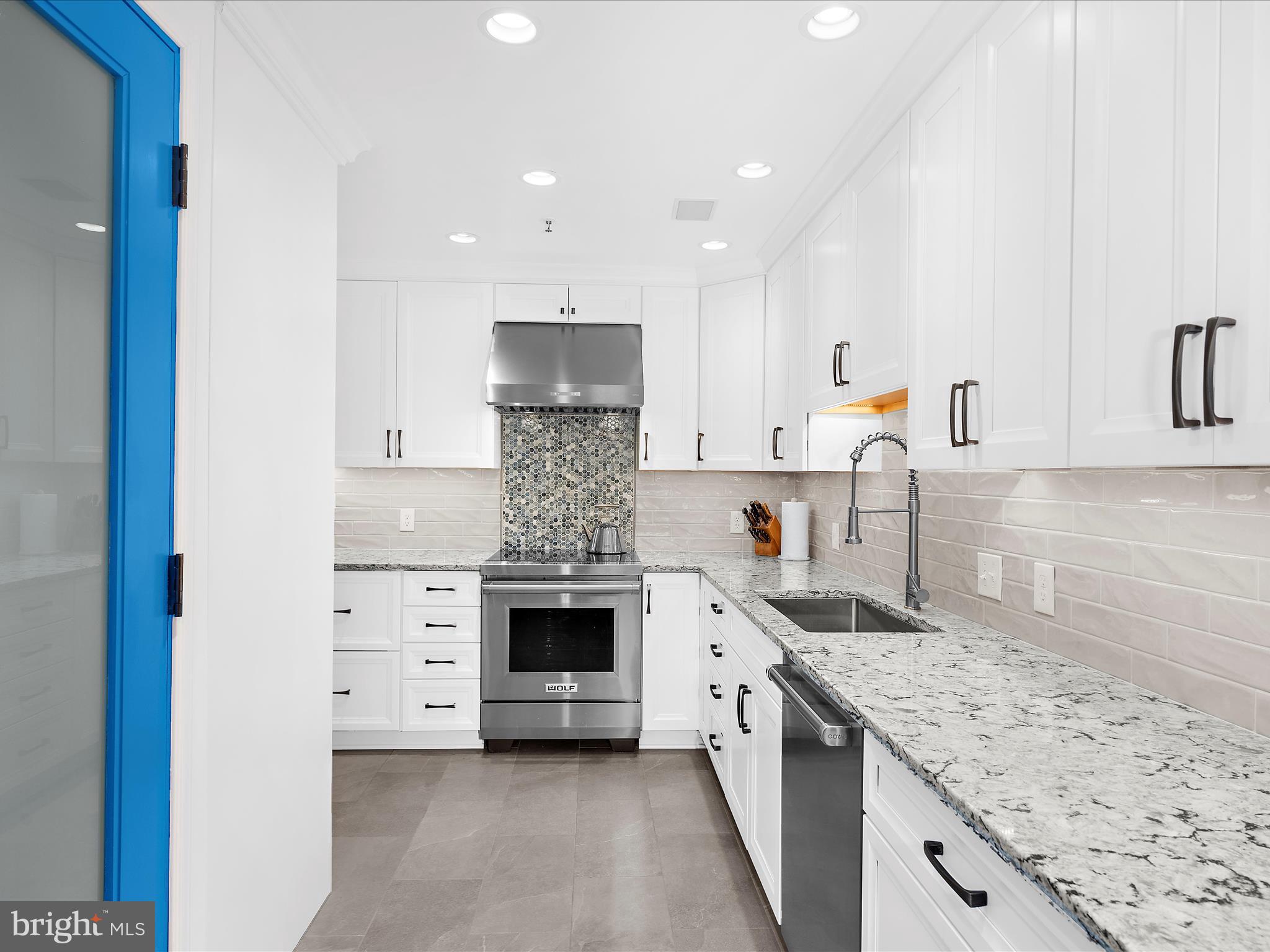 10 East Lee Street, Unit 2405 Baltimore, MD 21202 - Photo 10 of 50 a kitchen with a stove and cabinets