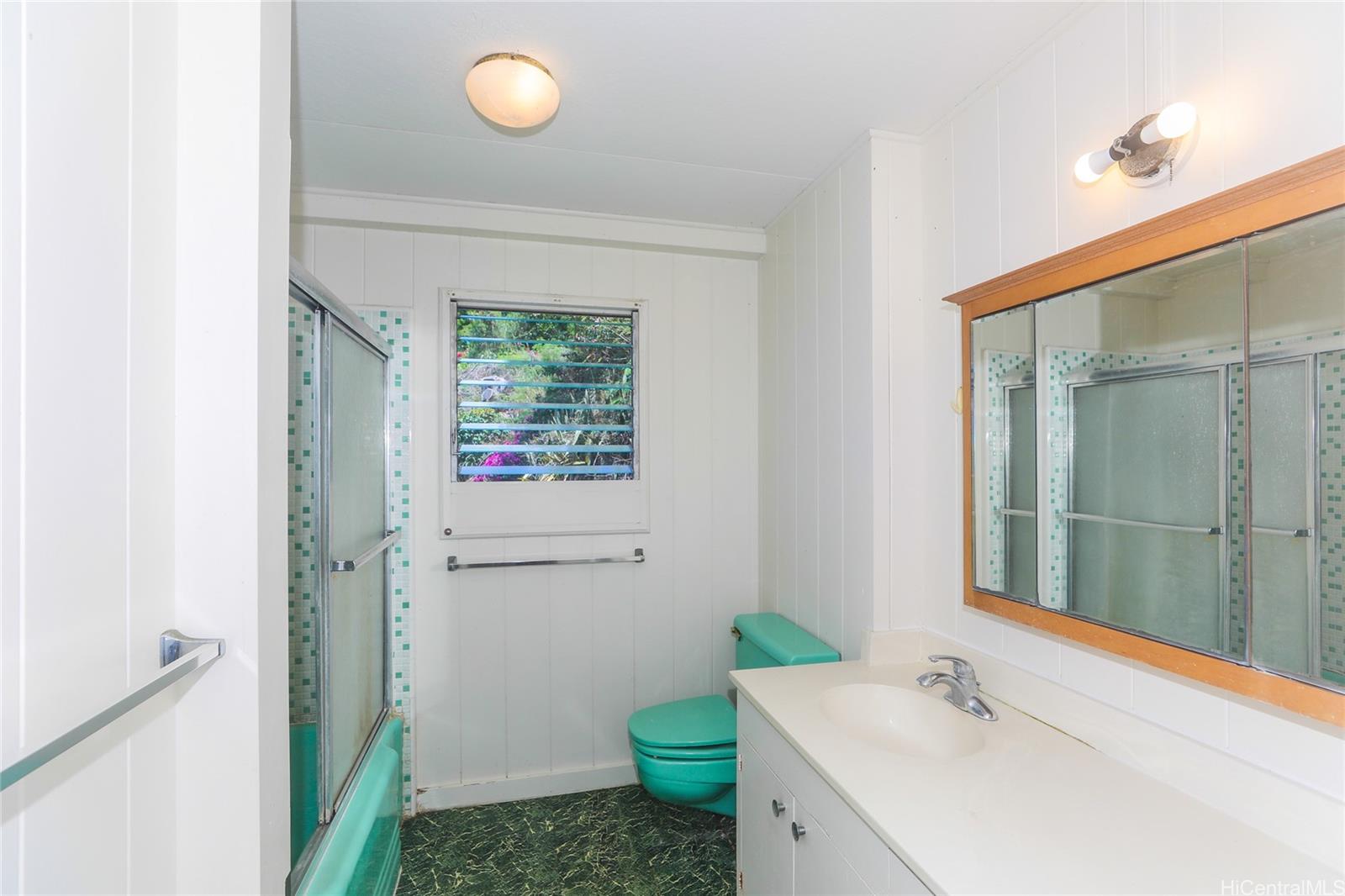1952 Nehoa Place Honolulu, HI 96822 - Photo 14 of 25 a bathroom with a sink and a mirror