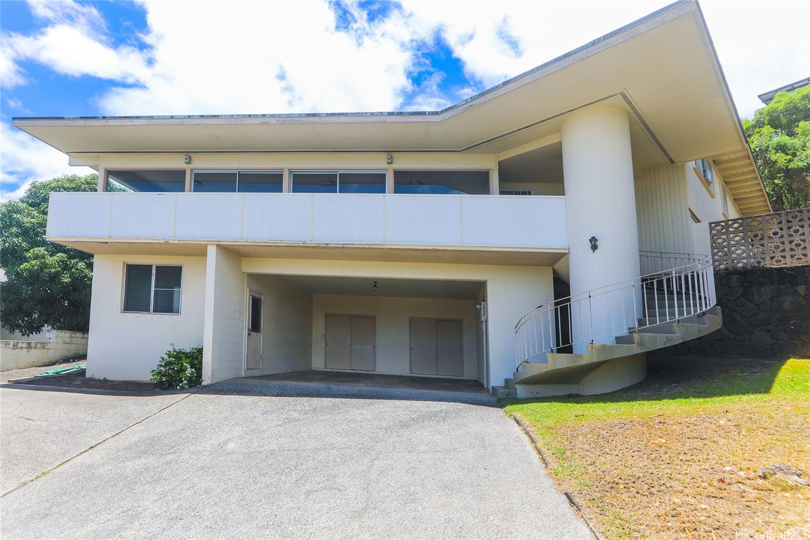 1952 Nehoa Place Honolulu, HI 96822 - Photo 2 of 25 a front view of a house with a yard and garage
