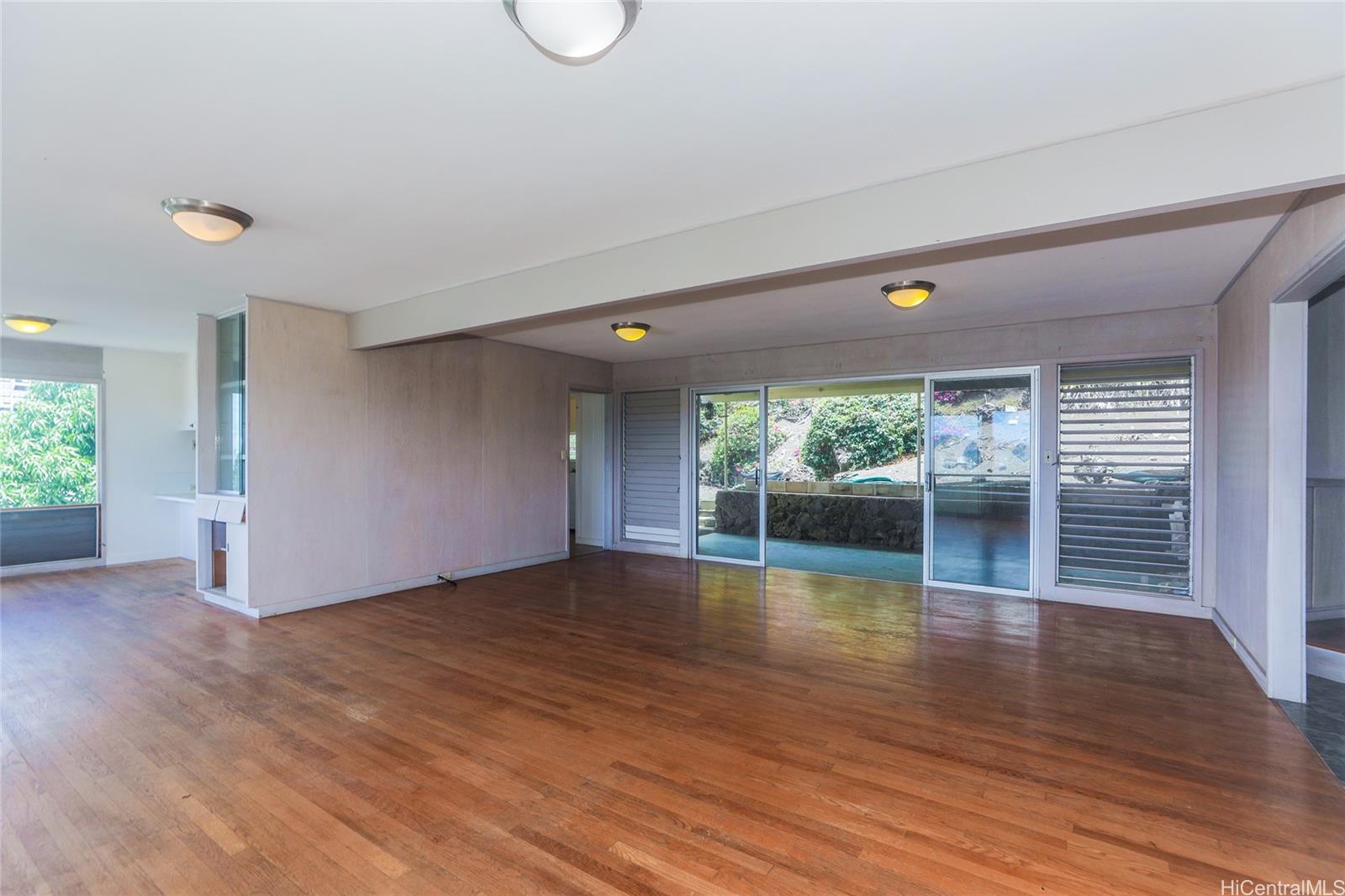 1952 Nehoa Place Honolulu, HI 96822 - Photo 4 of 25 a view of empty room with wooden floor and fireplace