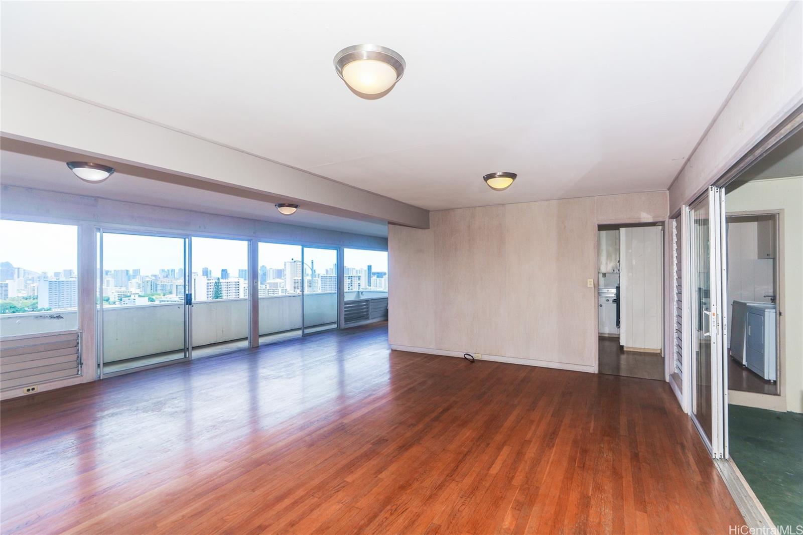 1952 Nehoa Place Honolulu, HI 96822 - Photo 5 of 25 a view of empty room with wooden floor and fan