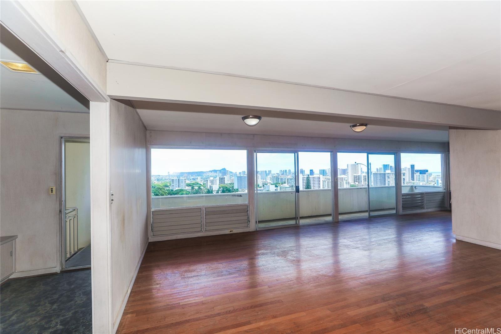 1952 Nehoa Place Honolulu, HI 96822 - Photo 6 of 25 a view of empty room with wooden floor and fan