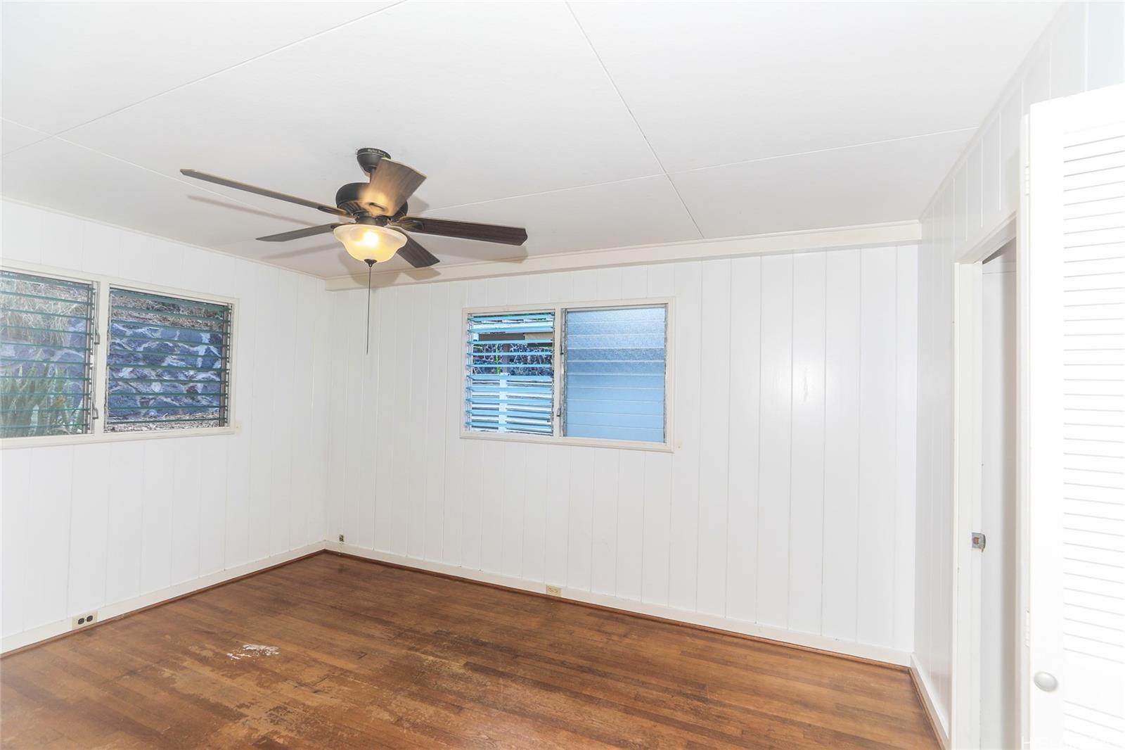 1952 Nehoa Place Honolulu, HI 96822 - Photo 10 of 25 a view of an empty room with wooden floor and a window