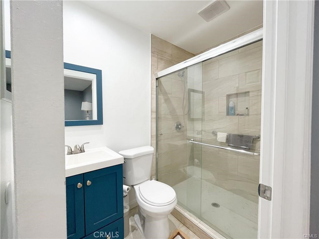 15980 Filbert Street Sylmar, CA 91342 - Photo 11 of 17 a bathroom with a toilet sink and shower
